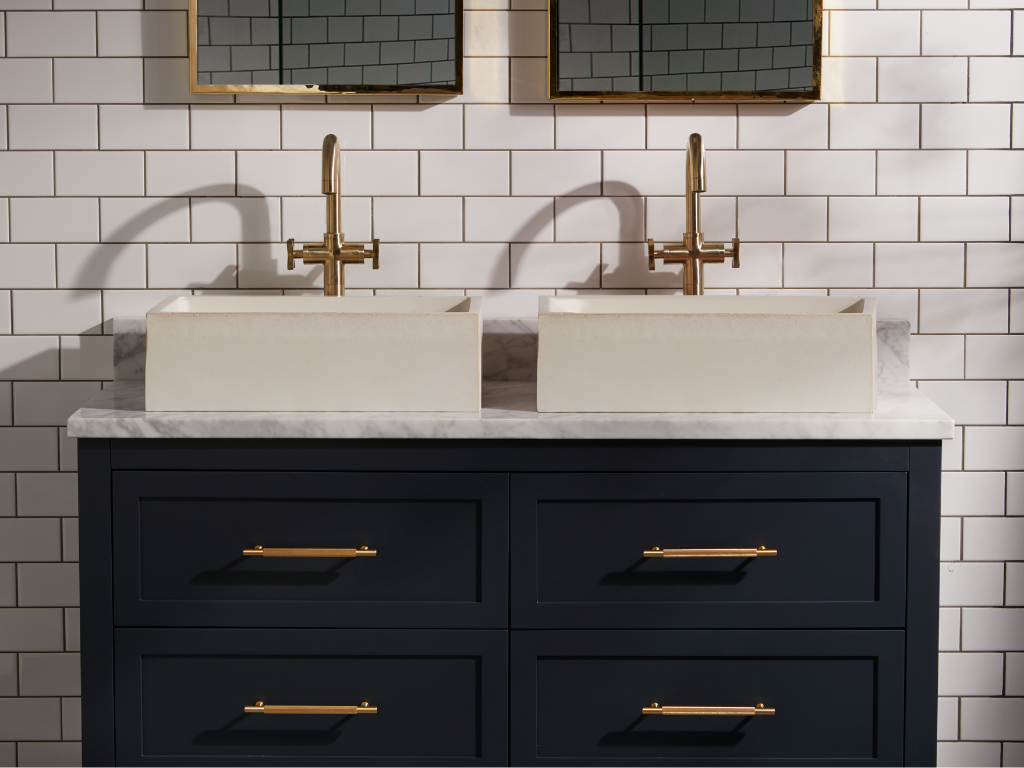 A dark, sophisticated bathroom featuring Crofts & Assinder handles on the bathroom cabinets