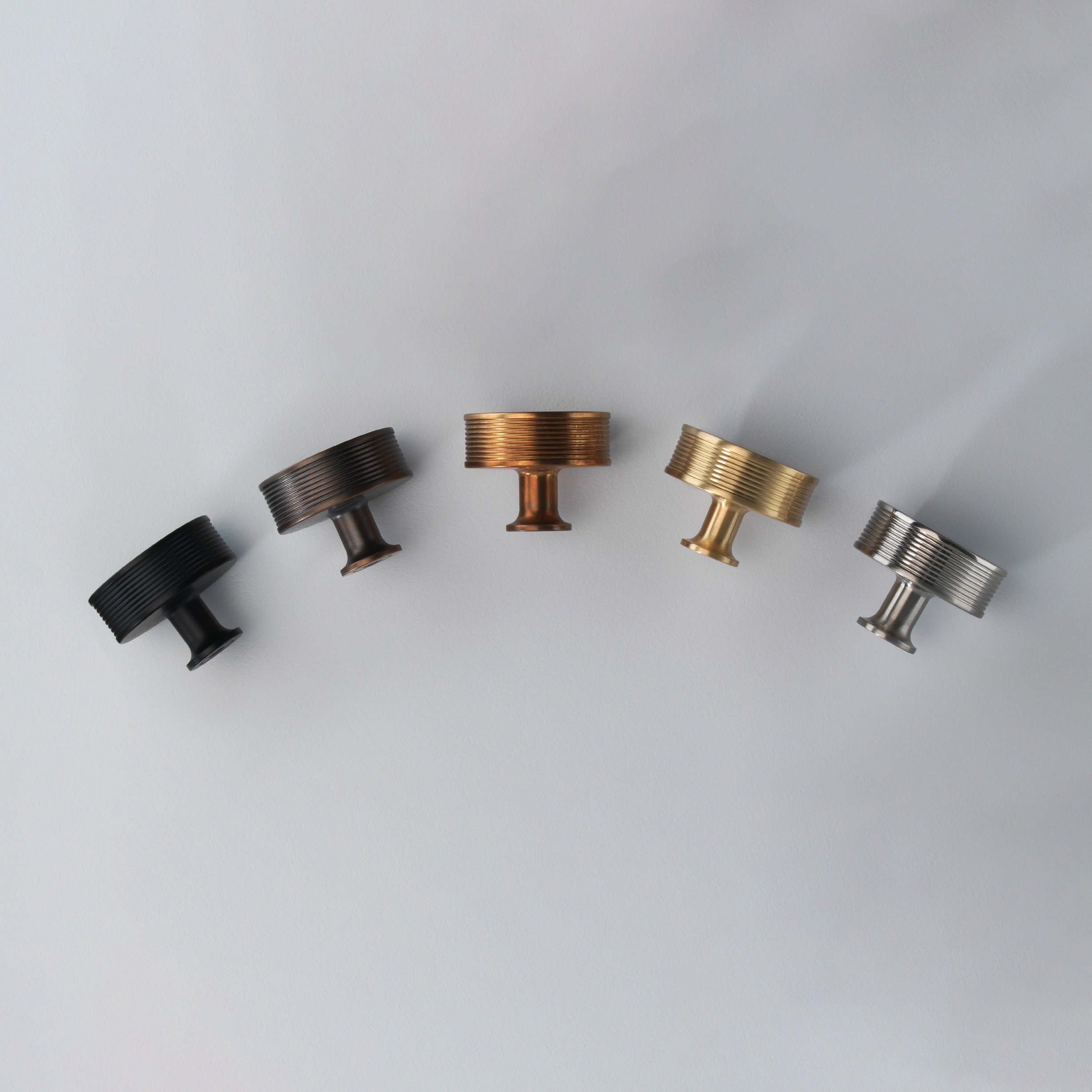 5 different coloured cabinet handles